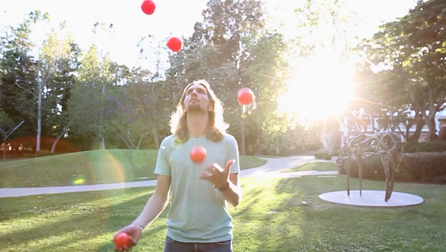 Man juggling five balls