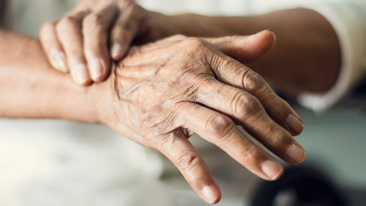 Elderly person holding hands