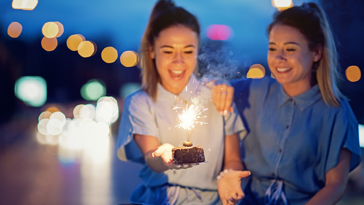 Twins sharing birthday cake