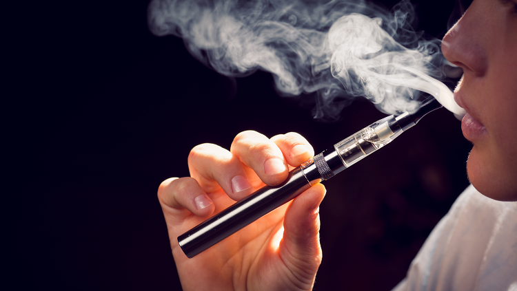 Photograph of a young person smoking an E-cigarette