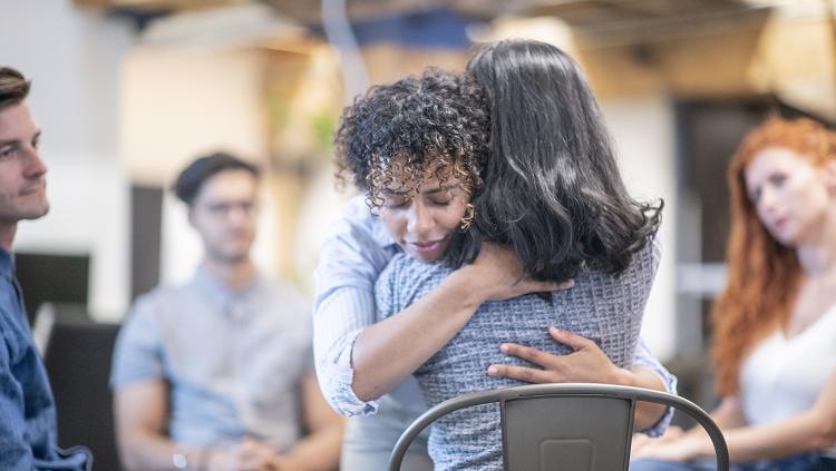 Photograph of two women hugging