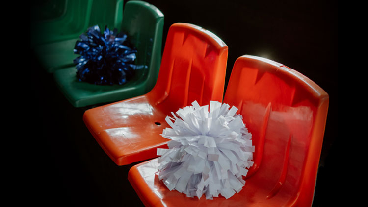 Empty seats with pom poms