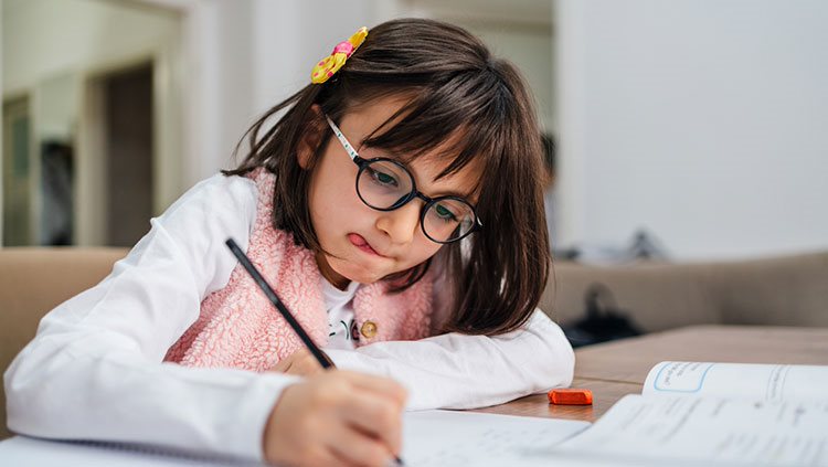 Little girl at desk working