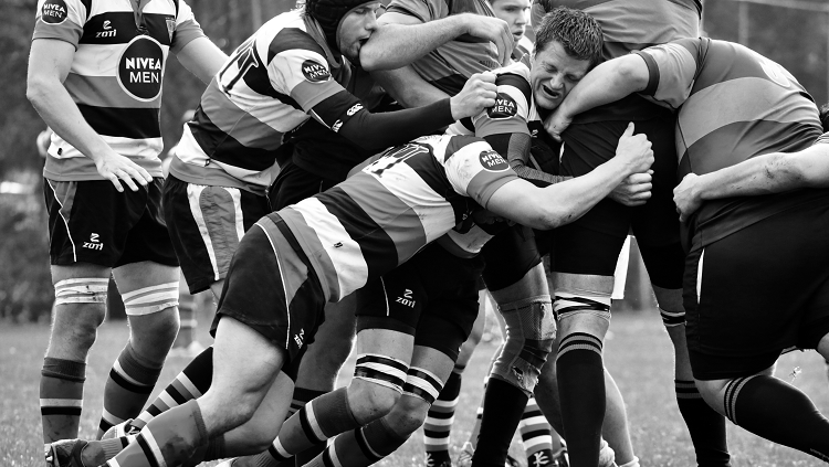 Image of rubgy players tackling 