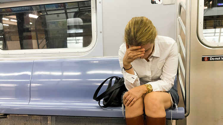 Image of a woman on a train having a panic attack