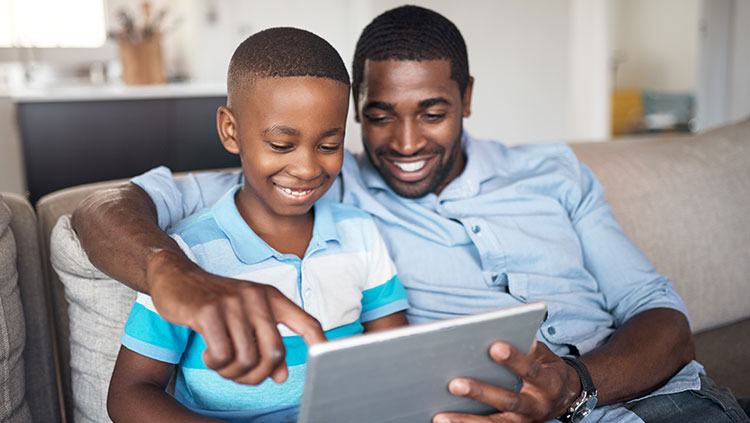 father and son looking at ipad