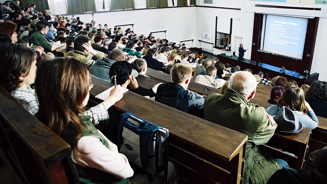 Audience members watching lecture