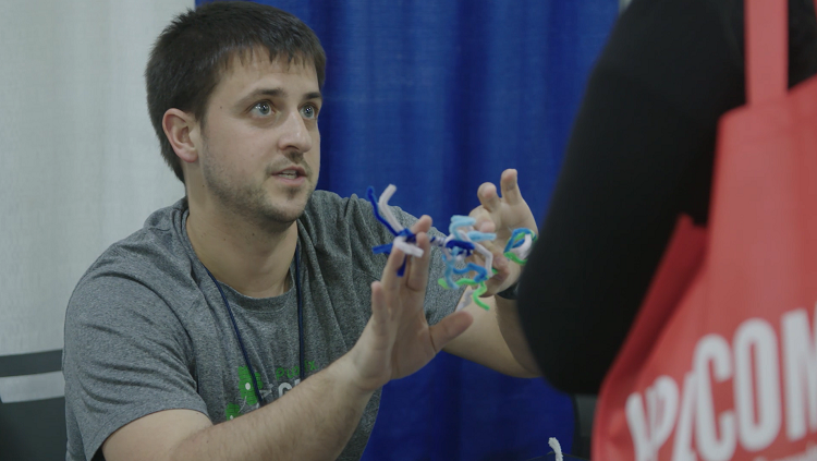 Neuroscientist Michael Caiola describes the parts of a neuron during an outreach event with teachers. 