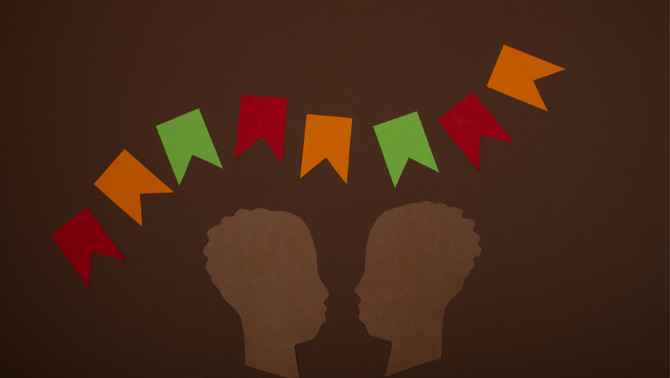 Two silhouettes looking at each othr with flags above