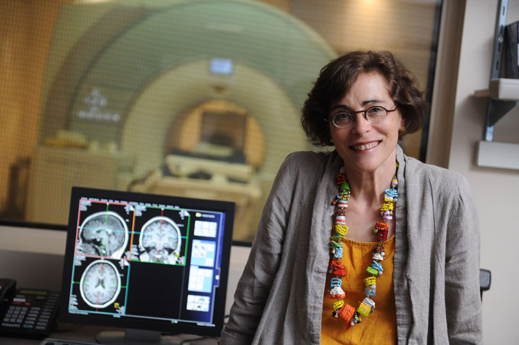 photo of marlene behrmann standing next to a computer