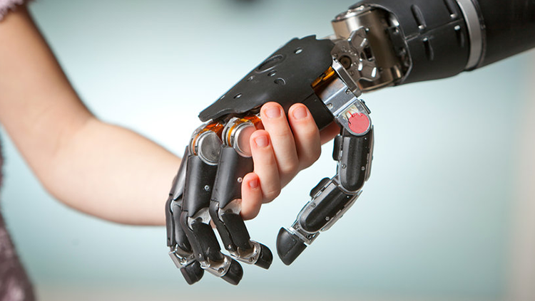 Image of a human hand holding a robotic hand