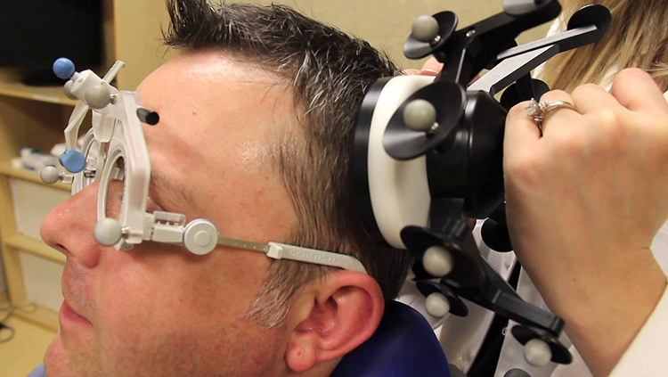 Image of man with a TMS machine on his head