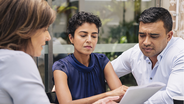 image of three people looking at a computer