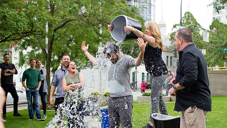 Woman dumping water on man