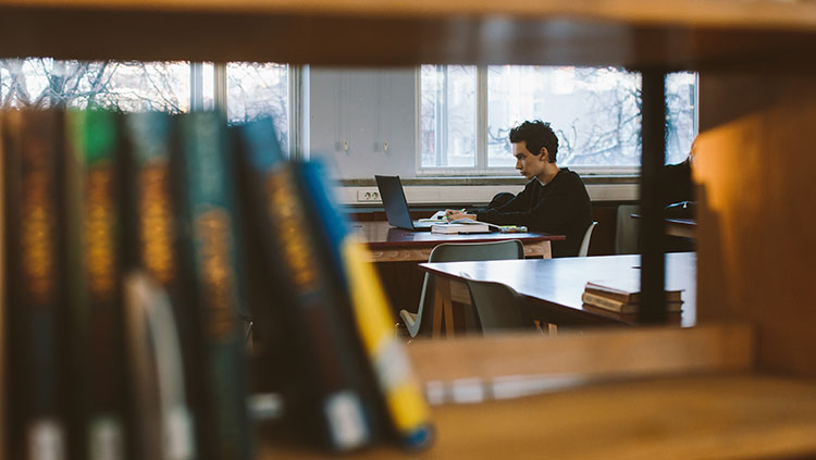 image of a man in a library with books