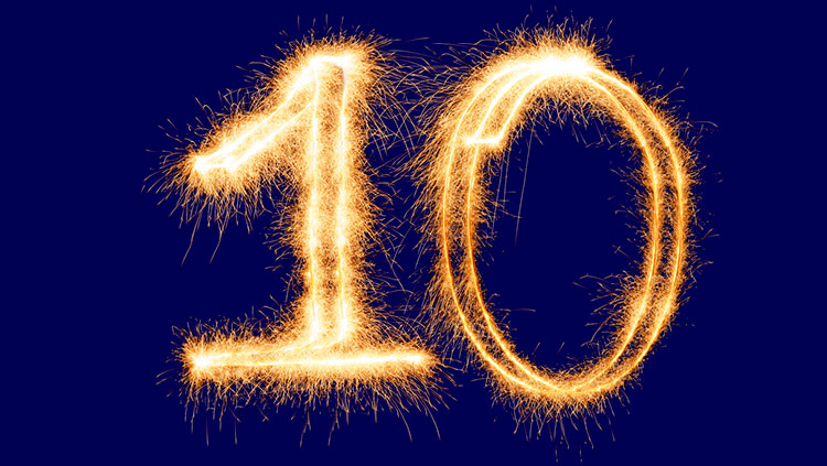 Gold glowing number 10 on navy blue background 