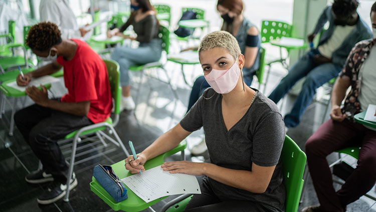 Woman with mask in classroom