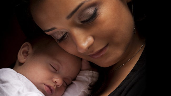 Mother holding baby.