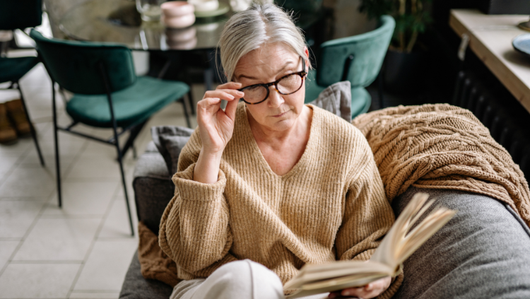 Woman sitting and reading on couch