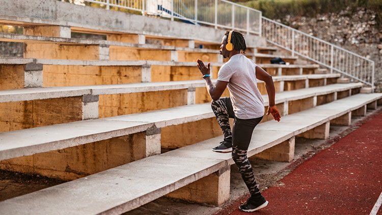 Woman running up the bleachers