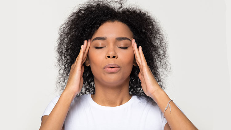 Woman holding her head in pain