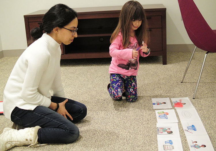 Rebecca Spencer working with young child